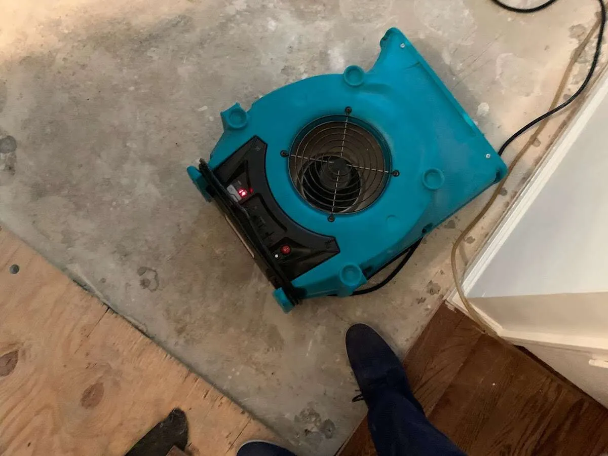 Air mover drying subfloor during Commercial Water Damage Restoration in Saddlebrooke